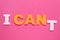 Motivation concept. Changing phrase from I Can\\\'t into I Can by removing paper letter T on pink background, top view