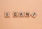 Motivation concept. Changing phrase from I Can\\\'t into I Can by removing square with letter T on pale coral background