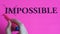 Motivational inscription impossible is possible on a pink background. Coaching, trainings, affirmations. Woman hand writes the