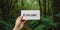 Motivational inspiring hand holding word card explore in woods