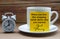 Motivational quote text on yellow notepad on coffee cup - When you feel like stopping think about why you started