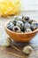 Motley quail eggs in a wooden bowl.