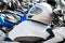 Moto helmet lies on the gas tank of a motorcycle and motorbikes on blurred background.