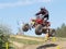 Moto quad jumping from hill