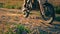 Motocross biker riding by on Powerful enduro motorcycle kicking up dust