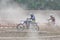 Motocross drivers in dust