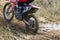 Motocross. Motorcyclist rushes along a dirt road, dirt flies from under the wheels.