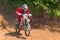 Motocross. Motorcyclist rushes along a dirt road, dust flies from under the wheels.