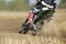 Motocross racer accelerating speed in track