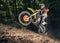 Motocross racer riding on forest