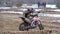 Motocross. Racer starts his motorcycle on the track. Off-road racing on enduro bikes. Slow motion