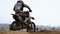 Motocross. Racer starts his motorcycle on the track. Off-road racing on enduro bikes. Slow motion