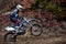 Motocross rider in action accelerating the motorbike on the race track