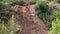 Motocross rider climbing steep slope on a sunny day