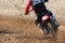 Motocross rider creates a huge cloud of dust and stone