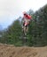 Motocross rider jumping a rise