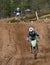 Motocross rider jumping a rise