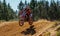 Motocross Rider Jumps a Dirt Berm