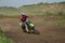 Motocross rider on motorcycle moves cornering