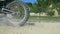 Motocross rider overcomes barrier of old tire. Enduro wheels overcome the obstacle. Close up Slow motion