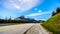 Motor Bikes driving the Duffey Lake Road surrounded by snow covered mountains