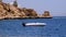 Motor boat at anchor in the sea against the landscape of rocky beach and the coastline in Egypt