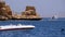 Motor boat at anchor in the sea against the landscape of rocky beach and the coastline in egypt