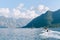 A motor boat cuts through the water in the Bay of Kotor in Montenegro. The concept of sea tourism and recreation.