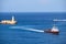 A motor boat enters to the Grand Harbour near the Saint Elmo Lighthouse, Valletta.