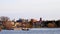 Motor boat glides by fishing pier on Lake Bemidji at Mississippi River on morning of Minnesota Fishing Opener.