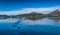 A motor boat in the lake surrounded by beautiful snowy mountains in Alesund Harbor, Norway