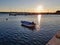 a motor boat in the sea sunset