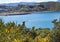 A motor boat speeds across Lyall Bay in WellingtoN, New Zealand. The airport is visible in the background