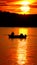 Motor boat with two passengers moving on a quiet autumn sea