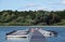 Motor boats for hire tied to a jetty at Hanningfield Reservoir, Essex.