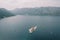 Motor boats sail around the island of Gospa od Skrpjela. Montenegro. Drone