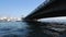 Motor boats sailing under bridge, transience of life, water tours, time-lapse