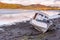 A motor cruiser boat lies on the mud waiting for the tide to return in Kippford, near Dalbeattie, in Dumfries and Galloway, Scotla