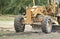 Motor grader machine civil constructionstripping to weed debris in site work. Tractor working in a field for prepared to