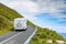 Motor home moving on a small narrow road in a mountains,