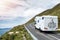 Motor home moving on a small narrow road in a mountains,