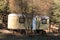 Motor home in park forest mountain in autumn vibrant woodland trees vacation weekend concept