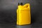 Motor oil in yellow canister on black background