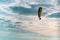 Motor paraglider flying in blue sky with white cloud in background.