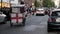 Motor scooters, a rickshaw and black London taxis driving on the streets around Covent Garden