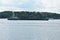 Motor ship barge on the Volga River. The water area of the city of Kostroma. A forest area. Blue sky