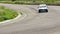 Motor sport car turning on asphalt track, driving high speed