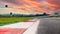 Motor sport circuit asphalt track background curb close up on straight and green field
