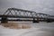 motor transport pedestrian bridge over the Luga river in winter cloudy time