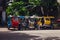 Motor tricycles lined up waiting for customers